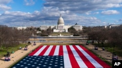 FILE - A large American flag is placed on the National Mall, with the US Capitol behind, ahead of the inauguration of President-elect Joe Biden and Vice President-elect Kamala Harris, Jan. 18, 2021.