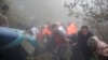 In this photo provided by Moj News Agency, rescue team members work at the scene of a crash of a helicopter carrying Iranian President Ebrahim Raisi in Varzaghan in northwestern Iran, May 20, 2024. 