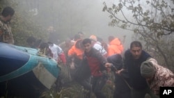 In this photo provided by Moj News Agency, rescue team members work at the scene of a crash of a helicopter carrying Iranian President Ebrahim Raisi in Varzaghan in northwestern Iran, May 20, 2024. 