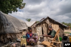FILE - People displaced by conflict sit in a camp in Komanda, Ituri province, eastern Democratic Republic of Congo, Aug. 30, 2023.