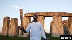 Stonehenge is still a place of ceremony. Last year, Michael Johnson was photographed with the Olympic torch at the stone circle before the London Olympic Games.