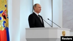 Russia's President Vladimir Putin delivers his annual state of the nation address to the Federal Assembly at the Kremlin in Moscow, Dec. 4, 2014.