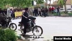 In this frame from a social media video posted April 13, 2018, people in Khorasgan, Iran march to protest water shortages that are hurting local farmers. 