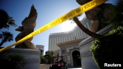 FILE - A member of the FBI leaves the Mandalay Bay Resort and Casino, from which Stephen Paddock shot and killed 58 people and wounded hundreds more on Oct. 1, in Las Vegas, Nevada, Oct. 4, 2017.