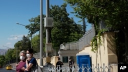 FILE - Turkish police officers stand guard outside the residence of Israeli embassy in Ankara, Turkey, May 21, 2021. 
