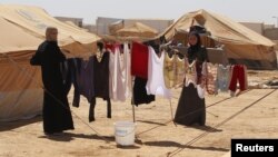 Syrian refugees hang clothes at Al Zaatri refugee camp in the Jordanian city of Mafraq, near the border with Syria, September 2, 2012.