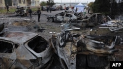 Local residents inspect burnt-out cars in the courtyard of a residential building following a drone attack in Odesa, Ukraine, on Nov. 9, 2024.