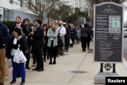 Congressional staffers wait in an excessively long line to enter the Dirksen Senate office building during the third day of a shut down of the federal government in Washington, Jan. 22, 2018.