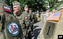 FILE - Polish Army and U.S. Army soldiers attend the opening ceremony of the Anaconda-16 military exercise, in Warsaw, Poland, June 6, 2016.