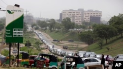 FILE - Vehicles queue up for fuel at a petrol station in Abuja, Nigeria, April 1, 2016. Militant attacks on oil facilities have created fuel shortages and raised prices.