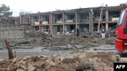 Afghan security personnel inspect the site of an attack on an army base in Gardez, capital of Paktia province, May 14, 2020.