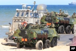 FILE - Soldiers sit atop amphibious vehicles as NATO troops participate in the BALTOPS 2015 sea exercises aimed at reassuring Baltic Sea region allies in the face of a resurgent Russia, in Ustka, Poland, June 17, 2015.