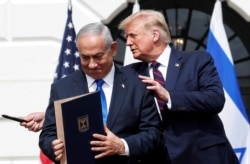 Israel's FILE - Prime Minister Benjamin Netanyahu stands with U.S. President Donald Trump after signing the Abraham Accords, on the South Lawn of the White House in Washington, Sept. 15, 2020.