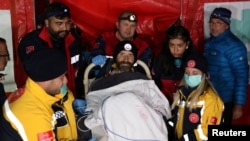 U.S. caver Mark Dickey, on a stretcher, is carried to an ambulance helicopter as his rescue operation comes to a successful end near Anamur in Mersin province, southern Turkey, Sept. 12, 2023. 