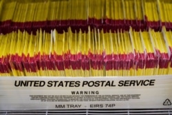 FILE - Returned ballots are shown at elections management center at the Salt Lake County Government Center Wednesday, Oct. 21, 2020, in Salt Lake City.