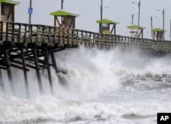 Waves from Hurricane Florence pound the Bogue Inlet Pier in Emerald Isle, N.C., Sept. 13, 2018.