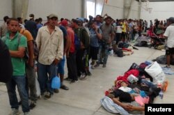 Central American migrants gather before continuing their journey to the U.S. despite President Donald Trump's vow to stamp out illegal immigration, in Ixtepec, Oaxaca, Mexico, March 31, 2018.