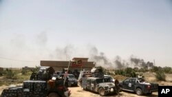 Smoke rises from Islamic State positions as Iraqi federal police take combat positions at the front line during fight against IS outside Fallujah, May 28, 2016. 
