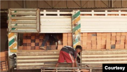 A young boy stacks bricks in Cambodia's Kandal province, July 23, 2019. (Courtesy - Sou Chhlonh) 