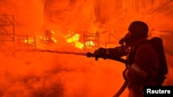 A firefighter works at a site of a Russian drone strike in Kharkiv, Ukraine, on May 4, 2024.