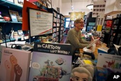 Dan Iddings, owner of Classic Lines, a bookstore about a half-mile from Tree of Life synagogue, works in his shop in Pittsburgh, Nov. 20, 2018.