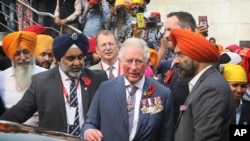 Britain's Prince Charles, center, prepares to leave after visiting Gurudwara Bangla Sahib, a Sikh Temple in New Delhi, India, Nov. 13, 2019. 