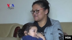 Kosal Chhim's wife, Sanghear Prak, with their daughter.