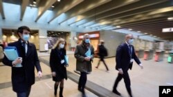 EU chief Brexit negotiator Michel Barnier, center, walks to the European Council building in Brussels, Dec. 8, 2020. Britain and the EU warned that talks on a post-Brexit free-trade deal are teetering on the brink of collapse.