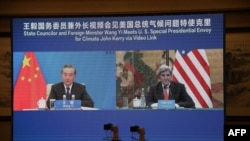 This handout photo taken Sept. 1, 2021, at an unspecified location shows a live image of U.S. climate envoy John Kerry (R) meeting via videolink with China's Foreign Minister Wang Yi (L) during Kerry's visit to Tianjin, China. (U.S. State Department)