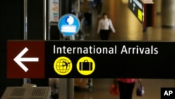 A sign for International Arrivals is shown at the Seattle-Tacoma International Airport in Seattle, June 26, 2017.