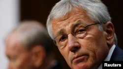 U.S. Secretary of Defense Chuck Hagel (R) and Chairman of the Joint Chiefs of Staff U.S. Army General Martin Dempsey testify before the Senate Armed Services Committee on Capitol Hill in Washington, March 5, 2014.