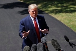 FILE - President Donald Trump speaks with reporters on the South Lawn of the White House, in Washington, Aug. 21, 2019.