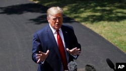 FILE - President Donald Trump speaks with reporters on the South Lawn of the White House, in Washington, Aug. 21, 2019.