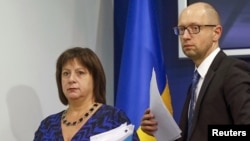 Ukraine's Prime Minister Arseny Yatseniuk and Finance Minister Natalia Yaresko leave a news conference in Kyiv, Ukraine, Oct. 15, 2015.