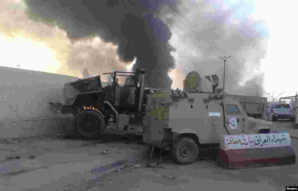 Damaged vehicles belonging to Iraqi security forces are seen during clashes between Iraqi security forces and the Islamic State in Iraq and the Levant in Mosul, Iraq, June 10, 2014.