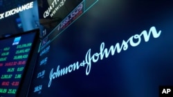 The Johnson & Johnson logo appears above a trading post on the floor of the New York Stock Exchange, Monday, July 12, 2021.