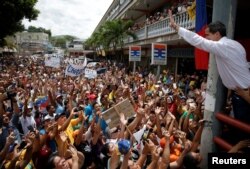 FILE - Venezuelan opposition leader Juan Guaido, who many nations have recognized as the country's rightful interim ruler, greets supporters during a gathering in Charallave, Venezuela, June 8, 2019.