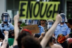 Protesters rally as Philadelphia police officers and Pennsylvania National Guard soldiers look on, in Philadelphia, June 1, 2020.