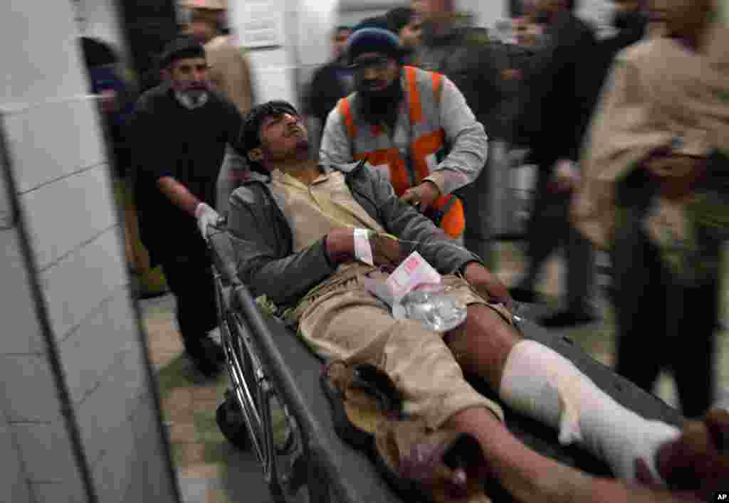A man who was injured in an explosion at a movie theater is brought to a hospital for treatment in Peshawar, Pakistan, Feb. 2, 2014.