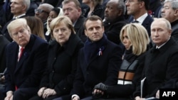 FILE - From left, President Donald Trump, German Chancellor Angela Merkel, French President Emmanuel Macron and his wife Brigitte Macron, and Russian President Vladimir Putin attend an Armistice Day ceremony in Paris, France, Nov. 11, 2018.