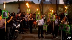 FILE - Protesters chant "Justice!" as they carry images of slain journalist Javier Valdez during a demonstration outside the Interior Ministry in Mexico City, May 16, 2017. Valdez, a veteran reporter who specialized in covering drug trafficking and organized crime, was slain in Sinaloa state. He was another victim in a wave of journalist killings in one of the world's most dangerous countries for media workers.