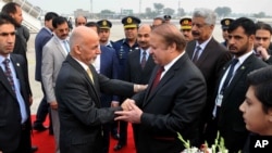FILE - Pakistani Prime Minister Nawaz Sharif, center right, greets Afghan President Ashraf Ghani, center left, upon his arrival at Nur Khan airbase in Rawalpindi, Pakistan, Dec. 9, 2015. 
