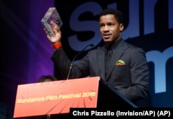 FILE - Nate Parker, the director, star and producer of "The Birth of a Nation," accepts the U.S. Dramatic Audience Award for the film during the 2016 Sundance Film Festival Awards Ceremony in Park City, Utah, Jan. 30, 2016.