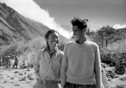 FILE - Sir Edmund Hillary (R) and Sherpa Tenzing Norgay smile during their first interview with Reuters after their climb to the top of Mount Everest (summit to right of Hillary's head) at camp in Thyangboche, Nepal in this June 6, 1953 file photo. (REUTERS/Peter Jackson/File)