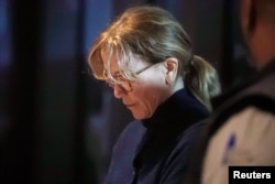 FILE - Actor Felicity Huffman departs an initial hearing for defendants in a racketeering case involving the allegedly fraudulent admission of children to elite universities, at the U.S. federal courthouse in downtown Los Angeles, California, March 12, 2019.
