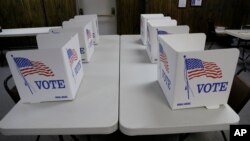 FILE - Voting booths await voters in Red Oak, Iowa.