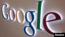 FILE - A Google sign is seen at a Best Buy electronics store in Encinitas, California, Apr. 11, 2013.