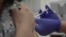 Screen grab taken from video issued by Oxford University, showing a person being injected as part of the first human trials in the UK to test a potential coronavirus vaccine, undertaken in England, April 23, 2020. 