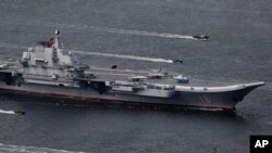 FILE -China's aircraft carrier Liaoning sails into Hong Kong to celebrate the 20th anniversary of the People's Liberation Army garrison's presence in the city on July 7, 2017. 