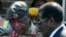 FILE - Zimbabwe's President Robert Mugabe, right, talks to General Constantine Chiwenga upon his arrival at Harare International Airport, July 4, 2008.